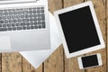 Tablet, computer, smartphone and paper on wood table Royalty Free Stock Photo