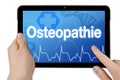 Tablet computer with touchscreen and the german word for osteopathy