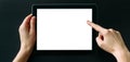 Tablet computer with white blank screen in hands isolated on black background. Holding and pointing to empty screen on digital Royalty Free Stock Photo