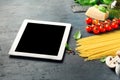 Tablet with copy space with Ingredients for cooking Italian past Royalty Free Stock Photo