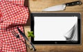 Tablet and Cutlery on a Table with Tablecloth Royalty Free Stock Photo
