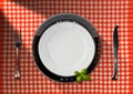 Tablet and Cutlery on a Table with Tablecloth Royalty Free Stock Photo