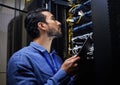 Tablet database, server room and engineer man looking at connection cables for maintenance or software update at night Royalty Free Stock Photo