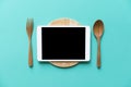 Tablet device served on wood plate Royalty Free Stock Photo