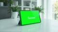 Tablet Displaying Success Message on Green Screen in Modern Office Royalty Free Stock Photo