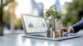 A tablet displays financial graphs and analytics alongside stacks of coins and a small tree symbolizing growth