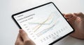 Hands holding a tablet displaying predictive ai demand planning with data charts Royalty Free Stock Photo