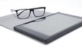 Tablet with blurred text and glasses Royalty Free Stock Photo