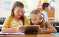 Tablet, friends and girls in classroom for education, elearning and online knowledge. Kindergarten, technology and kids Royalty Free Stock Photo