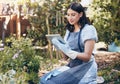 Tablet, gardening and woman with flowers for botany, growth or development in nature. Botanist, sustainable and female