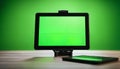 Tablet with Green Screen on a Wooden Table Royalty Free Stock Photo