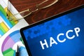 Tablet with HACCP on a table. Royalty Free Stock Photo