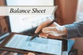 The tablet in the hands of a businessman. BALANCE SHEET concept