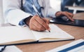 Tablet, hands and doctor writing in book on table, research and planning in hospital. Technology, notebook and medical Royalty Free Stock Photo