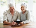 Tablet, happy senior couple and online in house with social media, reading news app and ebook. Retirement, old man and