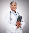 Tablet, happy woman and portrait of doctor in studio for healthcare services, telehealth support and help. Mature Royalty Free Stock Photo
