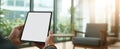 The Tablet Held in Hands Against a Modern Office Background.AI generated image Royalty Free Stock Photo