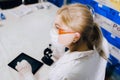 The tablet helps her to work smarter. A female student chemist, Royalty Free Stock Photo