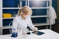 The tablet helps her to work smarter. A female student chemist, Royalty Free Stock Photo