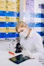 The tablet helps her to work smarter. A female student chemist, Royalty Free Stock Photo