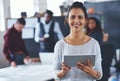 This tablet helps me get the job done. Cropped portrait of an attractive young businesswoman using a tablet in the