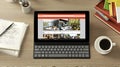 Tablet with keyboard on desk, showcasing image gallery Royalty Free Stock Photo