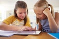 Tablet, kindergarten and girls in classroom for elearning, education and online knowledge. Friends, technology and Royalty Free Stock Photo