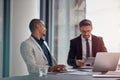 Tablet, laptop and business man with partner in corporate meeting, teamwork and planning or data analysis of profit Royalty Free Stock Photo