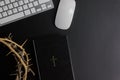 Tablet, laptop, mouse, thorn crown and Bible on the dark background Royalty Free Stock Photo