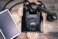 Tablet lying alongside a retro rotary telephone