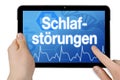 Tablet with medical background and the german word for sleep disorder