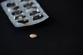 A tablet of medication on black background Royalty Free Stock Photo