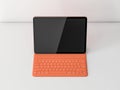 Tablet Mockup with orange keyboard case on white shelf