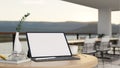 Tablet mockup on table over blurred background of modern outdoor restaurant seating space