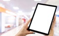 Tablet mockup in woman hand with business centre background. Modern tablet computer mock up with blank white screen. Empty space f Royalty Free Stock Photo