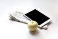 Tablet, newspaper and apple on white background Royalty Free Stock Photo