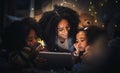 Tablet, night a mother reading to her children in a tent while camping in the bedroom of their home together. Black Royalty Free Stock Photo