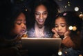 Tablet, night a woman reading to her children in a tent while camping in the bedroom of their home together. Black Royalty Free Stock Photo