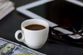 Tablet notepad, glasses and espresso coffee cup in the office cash american of US 100 dollars Royalty Free Stock Photo