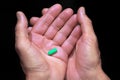 Pill in the palms of an old man Royalty Free Stock Photo