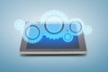 Tablet pc with cogwheel icon over screen