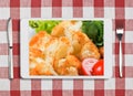 Tablet pc with dish, fork and knife on red checked tablecloth Royalty Free Stock Photo