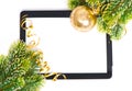 Tablet pc and golden ball and christmas tree Royalty Free Stock Photo