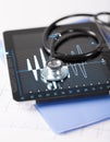 Tablet pc, stethoscope and electrocardiogram