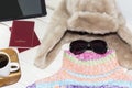 A tablet personal computer with a bright color sweater and warm hat. It is time to leave. Royalty Free Stock Photo