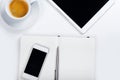 Tablet with phone and coffee cup on white table Royalty Free Stock Photo