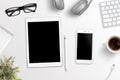Tablet and phone on office desk. Blank screen for mockup, app or responsive web site presentation Royalty Free Stock Photo