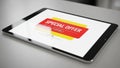 A tablet placed on a light gray surface displays a digital adv Royalty Free Stock Photo