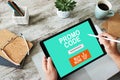 Tablet with promo code field on screen. E-commerce, mobile marketing concept. Royalty Free Stock Photo