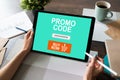 Tablet with promo code field on screen. E-commerce, mobile marketing concept.